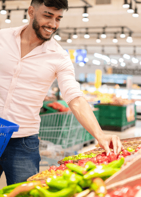 close-up-portrait-handsome-young-man-from-latin-america-picking-chili-supermarket 1